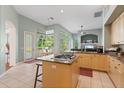 Spacious kitchen with an island, light wood cabinetry, and ample natural light at 1206 86Th Nw Ct, Bradenton, FL 34209