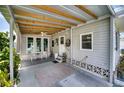 Covered patio with ceiling fan and seating area at 6428 Fleetwood Ct, North Port, FL 34287