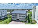 Aerial view of condo building with a metal roof and parking area at 1477 Park Beach Cir # 13, Punta Gorda, FL 33950