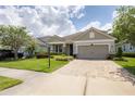 One-story home with gray siding, stone accents and a two-car garage at 5228 Bentgrass Way, Bradenton, FL 34211