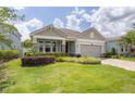 One-story home with gray siding, stone accents and a two-car garage at 5228 Bentgrass Way, Bradenton, FL 34211