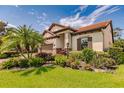 Single-story home with a landscaped yard and two-car garage at 4694 Royal Dornoch Cir, Bradenton, FL 34211