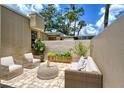 Relaxing patio with wicker furniture and potted plants at 2517 Glebe Farm Close # H-2, Sarasota, FL 34235