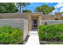 Condo exterior with gated entry and landscaped walkway at 2517 Glebe Farm Close # H-2, Sarasota, FL 34235