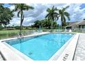 Community swimming pool with lounge chairs at 2517 Glebe Farm Close # H-2, Sarasota, FL 34235