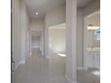 Bright and spacious hallway with tile flooring, leading to various rooms at 12390 Cedar Pass Trl, Parrish, FL 34219