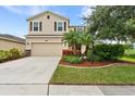 Two-story house with attached garage, manicured lawn, and landscaping at 5735 Broad River Run, Ellenton, FL 34222