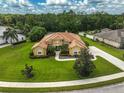 Expansive home with manicured lawn, beautiful landscaping, and a circular driveway at 14526 17Th E Ave, Bradenton, FL 34212