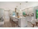 Renovated kitchen, featuring an island and breakfast bar at 7301 Ballantrae Pl # 27D, Sarasota, FL 34238