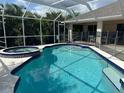 Inviting screened-in pool and spa with ample deck space at 139 Long Meadow Lane Ln, Rotonda West, FL 33947
