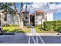 Condo building entrance with walkway and landscaping, offering curb appeal at 3245 Beneva Rd # 104, Sarasota, FL 34232