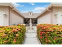Entryway with wrought iron gate and lush landscaping at 4113 Putter Pl, Bradenton, FL 34203