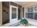 Screened entryway with sliding glass door and potted plants at 4113 Putter Pl, Bradenton, FL 34203