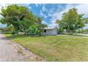 Single story home with a metal roof and mature landscaping at 2601 13Th W St, Palmetto, FL 34221