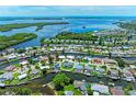 Aerial view showcases waterfront homes with backyard pools and private docks on picturesque canals at 5111 Coral Blvd, Bradenton, FL 34210
