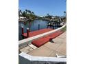 Newly stained wooden dock with access to the canal, set against a serene waterfront backdrop at 5111 Coral Blvd, Bradenton, FL 34210