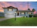 Charming two-story house featuring a well-maintained lawn and traditional architectural details at 5111 Coral Blvd, Bradenton, FL 34210