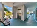 Building hallway with elevator access and bench at 12405 3Rd E St # 206, Treasure Island, FL 33706