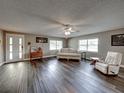 Spacious living room with hardwood floors, a sofa, and a comfy armchair at 1499 17Th W St, Palmetto, FL 34221