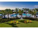 Relaxing pool area with lounge chairs and palm trees at 11671 Great Brook Ln, Parrish, FL 34219