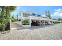 Modern building with covered parking and stairs at 826 Bayport Way # 826, Longboat Key, FL 34228