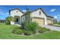 Charming single-Gathering home with a two-car garage, green lawn and fresh landscaping at 109 Corserra Dr, Nokomis, FL 34275