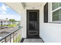 Condo entrance with a screened door and balcony overlooking the parking area at 304 47Th Avenue W Dr # 307, Bradenton, FL 34207