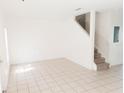 Spacious living room with tile floors and a staircase at 6209 Flagfish Ct, Lakewood Ranch, FL 34202