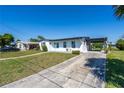 Newly renovated home with a driveway and well manicured lawn at 21306 Hepner Ave, Port Charlotte, FL 33952