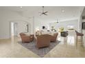 Open-concept living room features recessed lighting, neutral colors, ceiling fan, and tile flooring at 2232 River Ridge Dr, Sarasota, FL 34239