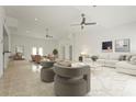 Spacious living room with neutral decor, ceiling fans, recessed lights, and a decorative area rug at 2232 River Ridge Dr, Sarasota, FL 34239