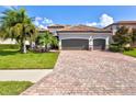 Two-story home with tile roof and paver driveway at 13303 Swiftwater Way, Lakewood Ranch, FL 34211