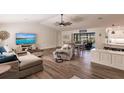 Bright living room with vaulted ceilings, comfy furniture, and a large TV at 1200 Via Tripoli, Punta Gorda, FL 33950