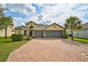 Two-story house with a three car garage and brick driveway at 5514 69Th E Pl, Ellenton, FL 34222