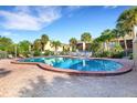 Relaxing kidney-shaped pool with lounge chairs at 3413 Clark Rd # 114, Sarasota, FL 34231