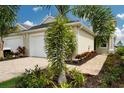 Tan house exterior with white garage door and landscaping at 10748 Klee Ave, Bradenton, FL 34212