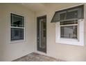 Front entry with glass door and gray window shutters at 10748 Klee Ave, Bradenton, FL 34212