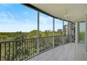 Spacious balcony overlooking lush landscape and water at 393 N Point Rd # 503, Osprey, FL 34229