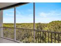 Serene balcony view overlooking water and trees at 393 N Point Rd # 503, Osprey, FL 34229