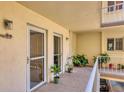 Private balcony with potted plants and exterior door at 1714 69Th W Ave # B205, Bradenton, FL 34207