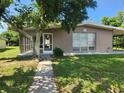 Single story house with carport, screened porch, and well-maintained lawn at 21154 Bersell Ave, Port Charlotte, FL 33952