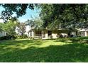 Spacious backyard featuring a covered patio and mature trees providing ample shade at 4072 Fairway Pl, North Port, FL 34287