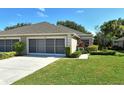 Well-kept home exterior showing attached garage and pristine front lawn at 4072 Fairway Pl, North Port, FL 34287