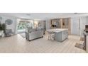 Open kitchen and living area with island and pool view at 4108 101St W St, Bradenton, FL 34210