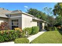 Well-manicured landscaping surrounds this charming house exterior at 4072 Fairway Pl, North Port, FL 34287
