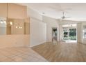 Spacious living room with vinyl flooring and access to a screened patio at 4072 Fairway Pl, North Port, FL 34287