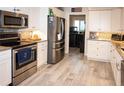 Modern kitchen with stainless steel appliances and granite countertops at 6772 Greenview Ln, Englewood, FL 34224