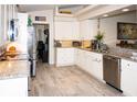 Modern kitchen with stainless steel appliances and granite countertops at 6772 Greenview Ln, Englewood, FL 34224