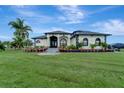 Spacious house with a large yard and palm trees at 12307 S Access Rd, Port Charlotte, FL 33981