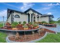 Landscaped home with a curved walkway and lush greenery at 12307 S Access Rd, Port Charlotte, FL 33981